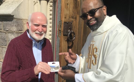 Mike O'Rourke accepts Lowes' gift card from Father Sam